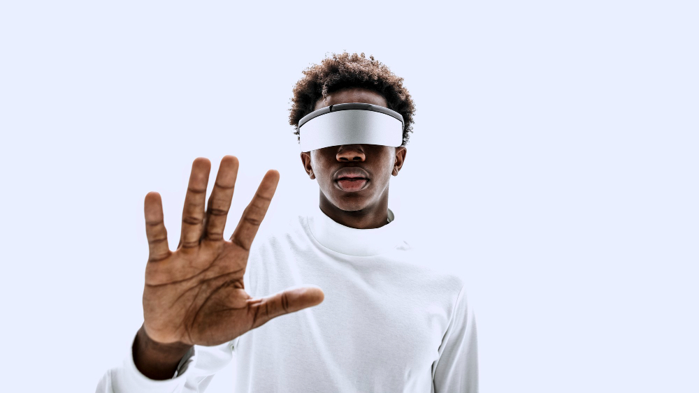 Man in VR glasses reaching out to touch a virtual display