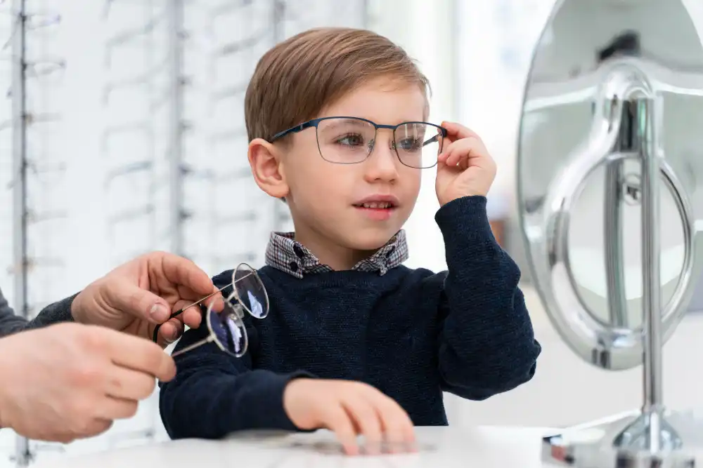 Little boy trying on glasses at an optics store