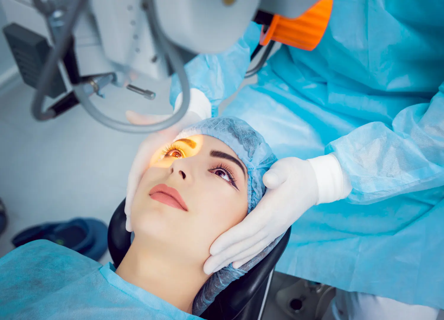 Patient undergoing an eye procedure with focused illumination on the eye